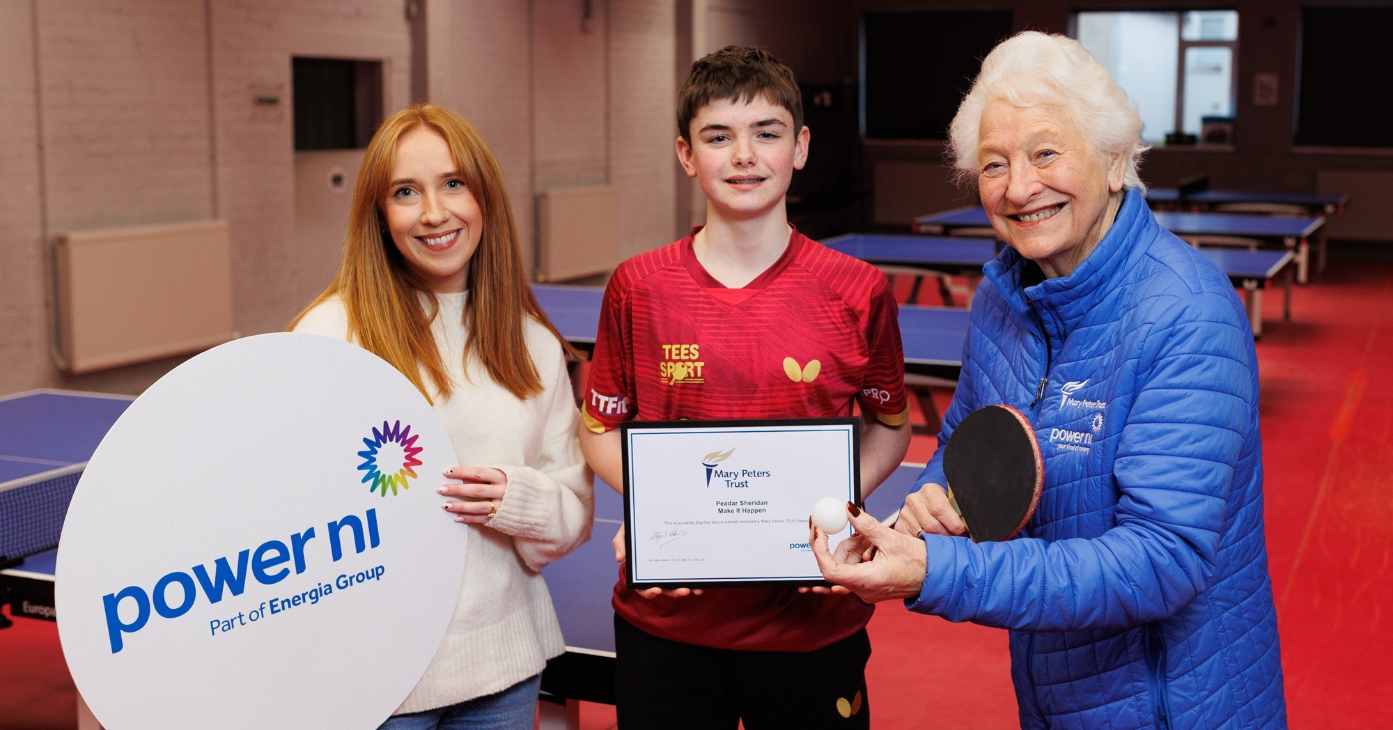 Club members with sponsor banners